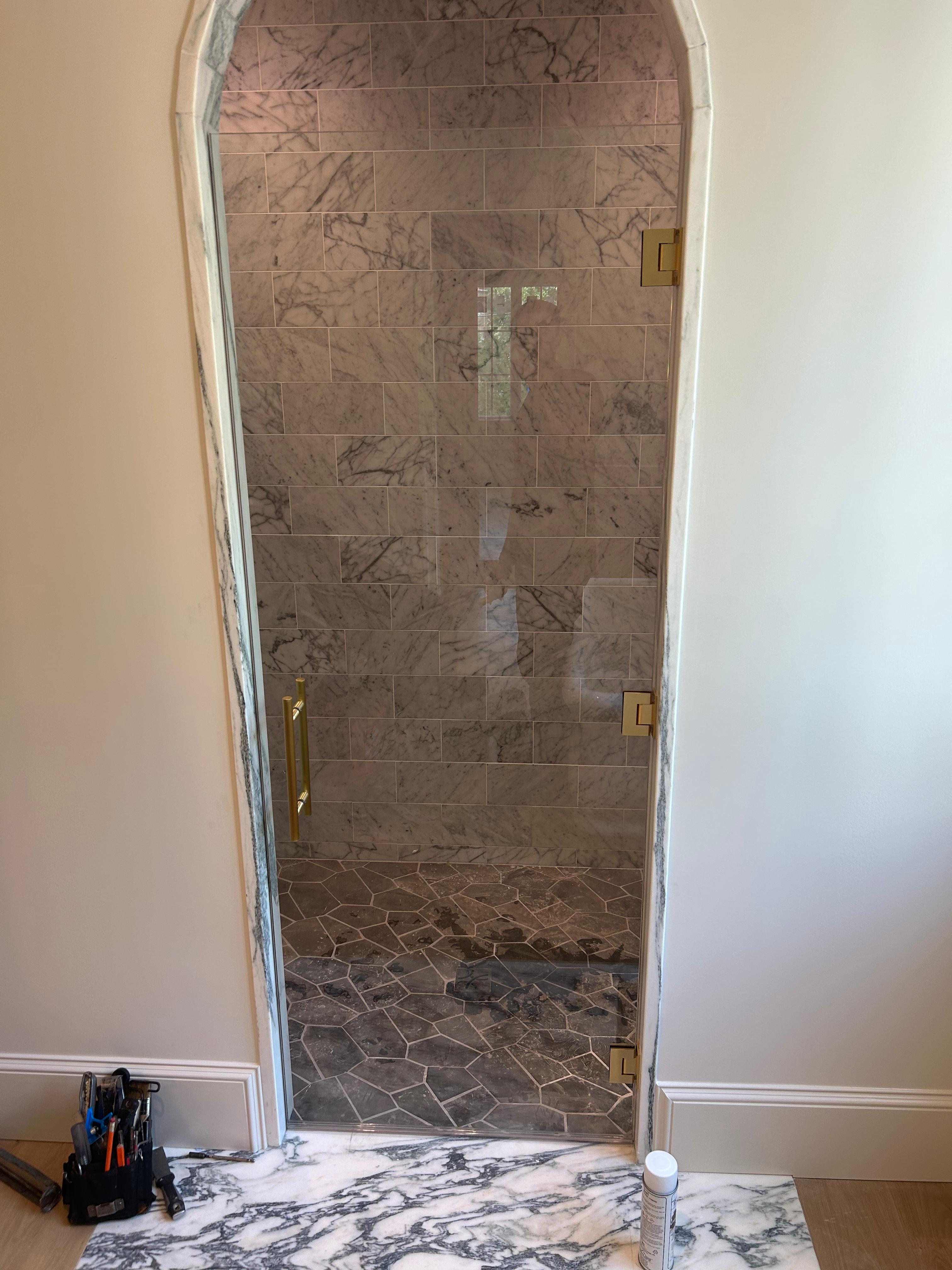 Glass shower door installed in newly renovated bathroom